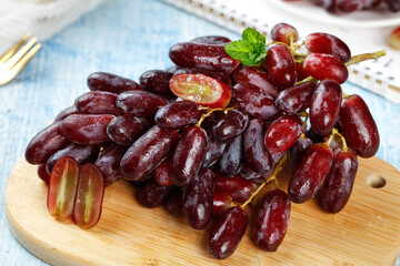 Fresh Red Finger Grapes on Wooden Board with Mint Garnish - Healthy Fruit Snack