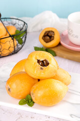 Fresh Yunnan Mountain Loquat Fruits on White Marble - Healthy Asian Stone Fruit Display