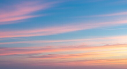Celestial canvas of a gentle sunrise, with soft pink and yellow clouds painting the serene blue sky at dawn