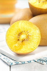 Golden Kiwi Fruit Cut in Half Showing Yellow Heart Center - Fresh New Zealand Imported Tropical Fruit