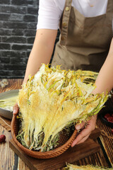 Chef Displaying Dried Cauliflower in Wooden Bowl - Traditional Food Preparation