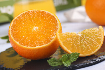 Fresh Orange Halves and Slice with Mint on Slate Board - Citrus Fruit Display