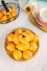 Fresh Yunnan Loquat Fruits Peak Season Display in Bamboo Basket with Traditional Tea Setting