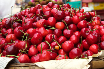 Fresh Red Cherries Stacked at Market - Ripe Summer Fruit Display