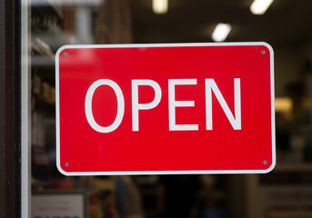 Bright red open sign welcomes customers to shop now and explore the store's offerings today