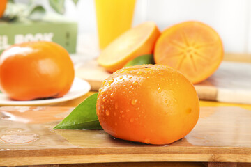 Fresh Shanxi Persimmons with Water Droplets on Wooden Cutting Board - Crisp Orange Fruit Details