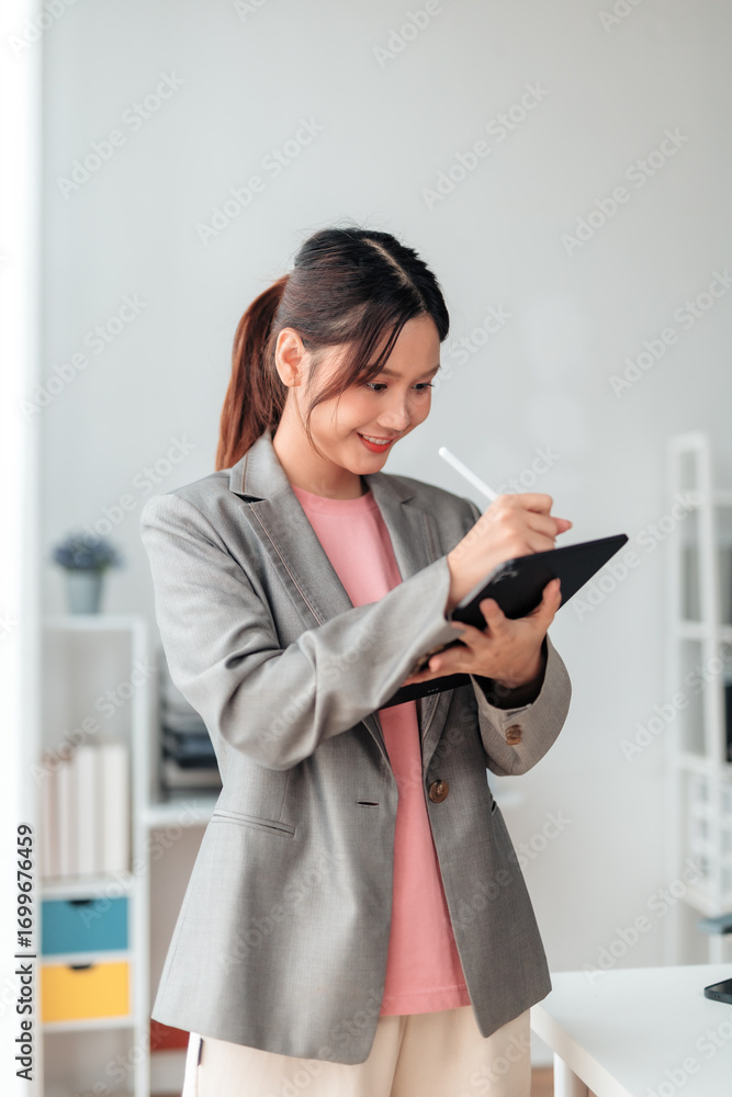 Poster smiling businesswoman using digital tablet and stylus pen taking notes, browsing internet or working