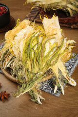 Traditional Chinese Dried Medicinal Herbs and Botanical Ingredients on Wooden Background