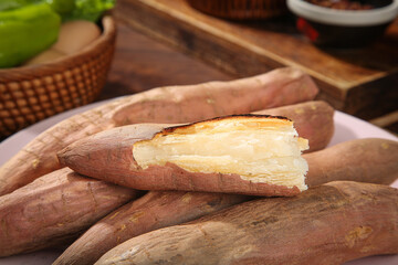 Roasted Sweet Potatoes with Golden Flesh on Wooden Background