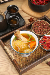 Traditional Chinese Herbal Chicken Soup with Dried Ingredients and Spices on Bamboo Tray - Zhaoqing Health Food