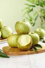 Fresh Jinshuai Apples from Shandong China - Sweet and Sour Green Apple Variety on Wooden Board