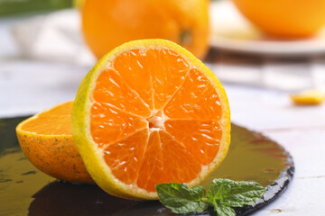 Fresh Sliced Citrus Oranges with Mint Garnish on Wooden Cutting Board