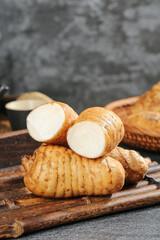Freshly dug yacon tubers from Zhaotong mountains with white flesh on wooden board