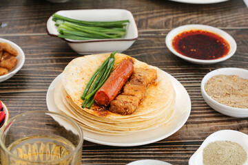 Zibo BBQ Specialties - Grilled Meat and Sausage on Flatbread with Traditional Chinese Condiments