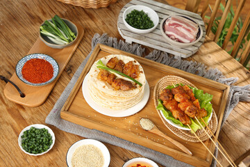 Gourmet Grilled Meat Skewers with Flatbread and Fresh Ingredients on Wooden Serving Tray