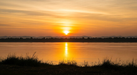 Fototapeta premium Nong Khai Mekong River sunset reflections - Thailand river landscape