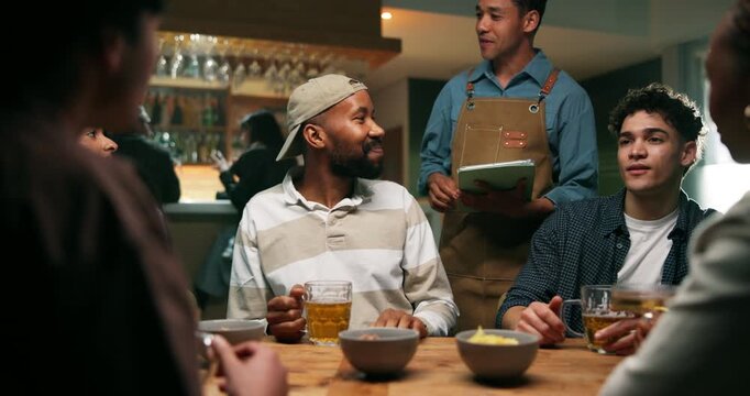 Friends, waiter and talk at bar for drinks order, happy and relax for bonding for social gathering. People, men and woman with beer, conversation and smile with barman, tablet or digital menu in pub
