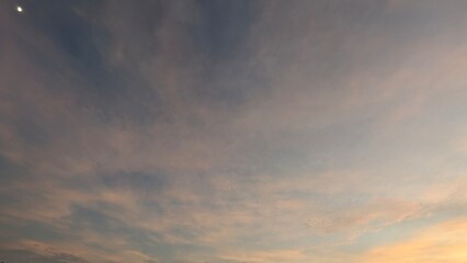 A stunning sunrise sky features a beautiful gradient of deep blues and purples transitioning into...