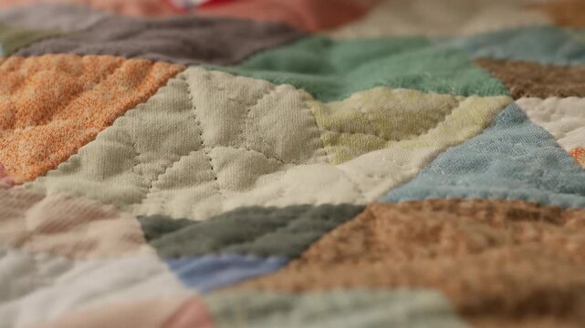 Colorful patchwork quilt detail showing stitching