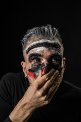 Man with Painted Face Covering Mouth Expression