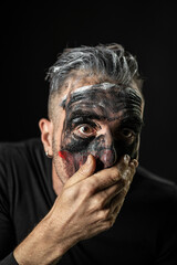 Man with Painted Face Covering Mouth Expression