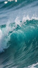 Obraz premium Dynamic teal ocean swell breaking near shore