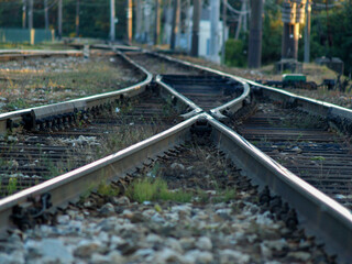 Close-up view of railway switch and rails converging.