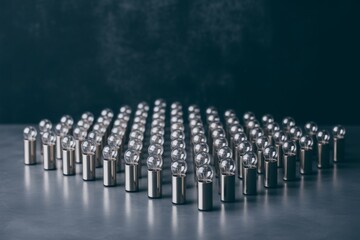 Fototapeta premium Precise arrangement of many shiny metallic electrical wire connectors on a reflective surface