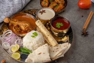 Kolhapuri chicken Thali is a popular Indian asian food platter consists of poultry meat, chikan...