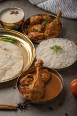 Kolhapuri chicken Thali is a popular Indian asian food platter consists of poultry meat, chikan sukka bhakri, rice, salad tambda padhra rassa 