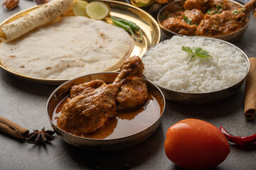 Kolhapuri chicken Thali is a popular Indian asian food platter consists of poultry meat, chikan sukka bhakri, rice, salad tambda padhra rassa 