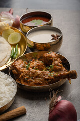 Kolhapuri chicken Thali is a popular Indian asian food platter consists of poultry meat, chikan sukka bhakri, rice, salad tambda padhra rassa 