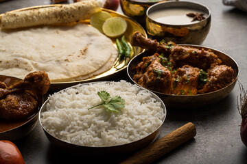 Kolhapuri chicken Thali is a popular Indian asian food platter consists of poultry meat, chikan sukka bhakri, rice, salad tambda padhra rassa 