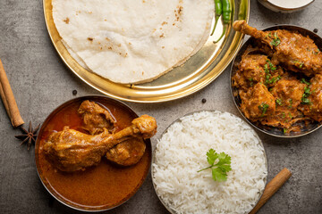 Kolhapuri chicken Thali is a popular Indian asian food platter consists of poultry meat, chikan sukka bhakri, rice, salad tambda padhra rassa 