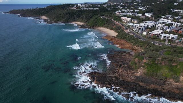 Rocky Coast Of Coolum Beach With Oceanfront Buildings In Queensland, Australia. - aerial shot