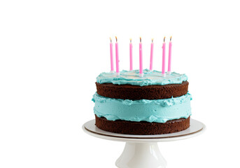 Isolated birthday chocolate cake with light blue frosting and pink candles for celebration