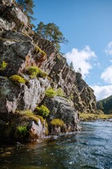 Dramatic Rugged Rock Cliffs with Flowing River
