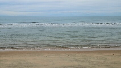 Tropical beach landscape with sand beach on couldy day sin rain season.