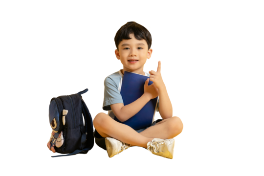 Asian kid A young child is sitting, holding a book with a backpack beside him on PNG