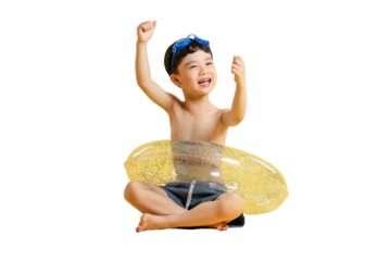 Asian kid A happy young boy with a swimming ring sitting happily on the ground, ready for fun in PNG