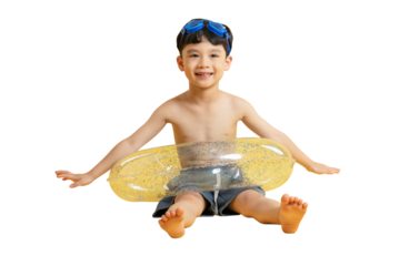 Asian kid A cheerful young boy prepares for a swim, wearing goggles and a float ring on PNG