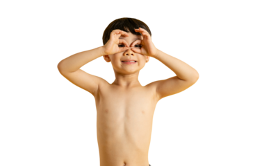 Asian A joyful young boy making binoculars with his hands, smiling and looking at the camera. He is showing his playful attitude and curiousity on PNG