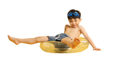 Asian young boy enjoying a relaxing time on a floaty with his swimming goggles on PNG