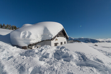 Small house covered in snow