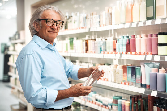Senior man choosing healthcare products at the pharmacy