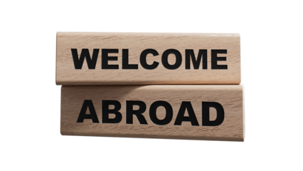 Text WELCOME ABROAD on a sticker on the calculator, business concept. wooden blocks. Copy space.Supports PNG files with transparent backgrounds.
