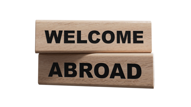Text WELCOME ABROAD on a sticker on the calculator, business concept. wooden blocks. Copy space.Supports PNG files with transparent backgrounds.