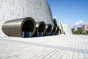 Modern building space with stone walls and paved ground
