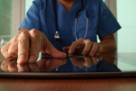 Doctor using digital tablet for online healthcare