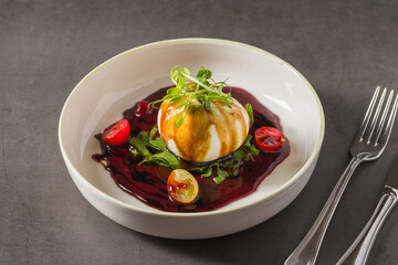 Creamy burrata cheese with beet sauce, arugula and cherry tomatoes